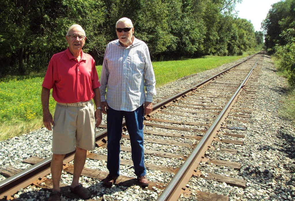 McNamara, left, and Nelson stand on the railroad tracks that divided the five western opening holes at Valley View from its four eastern closing holes.